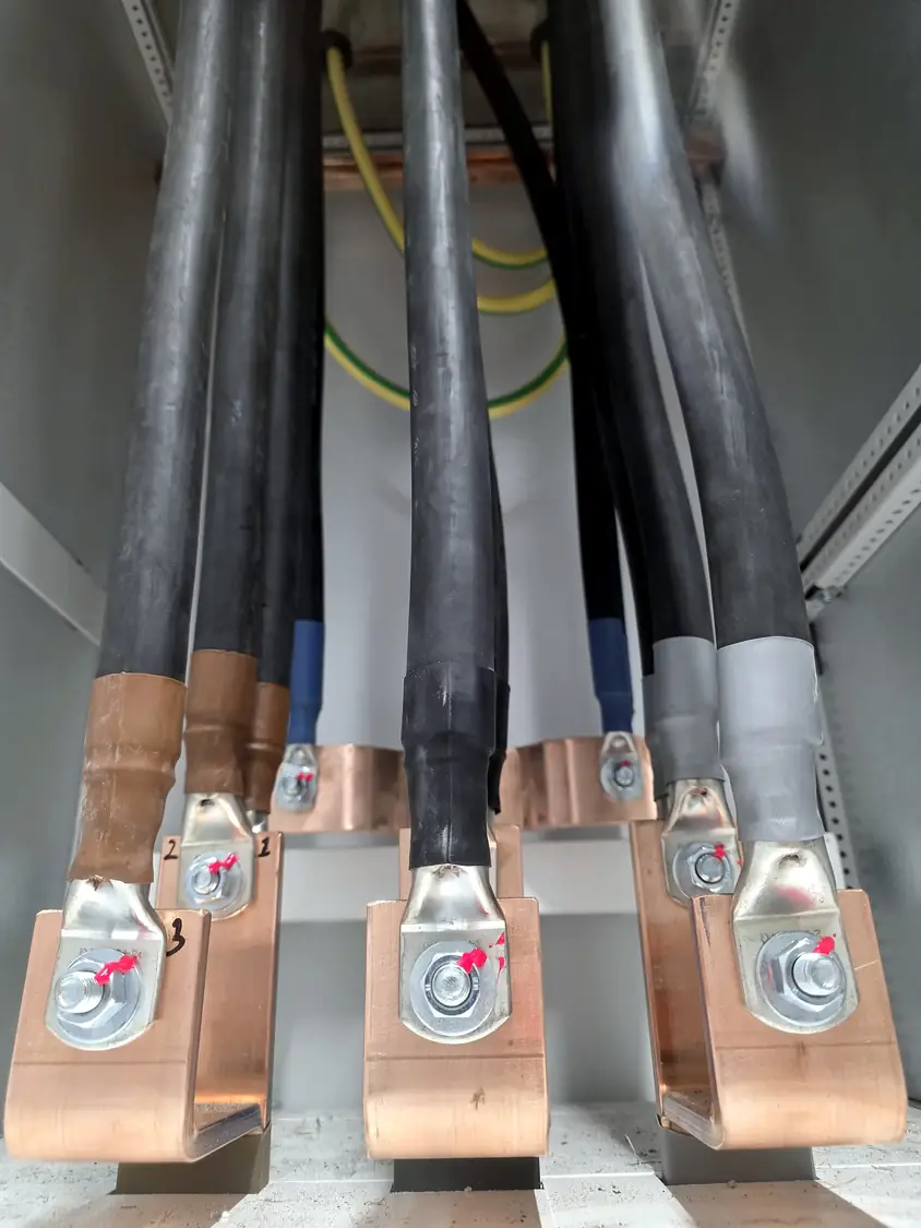 Cable lugs bolted to copper busbars