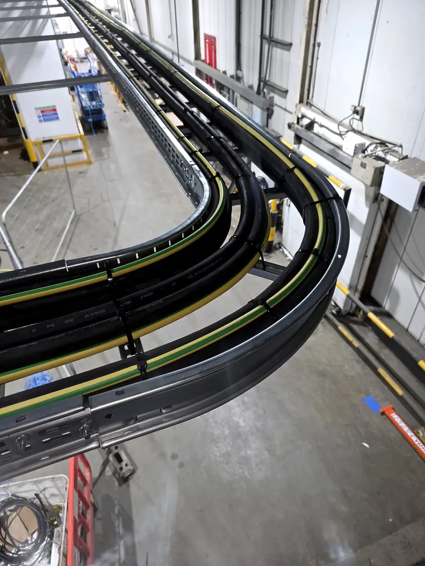 Large AC cables on ladder rack bends, seen from above