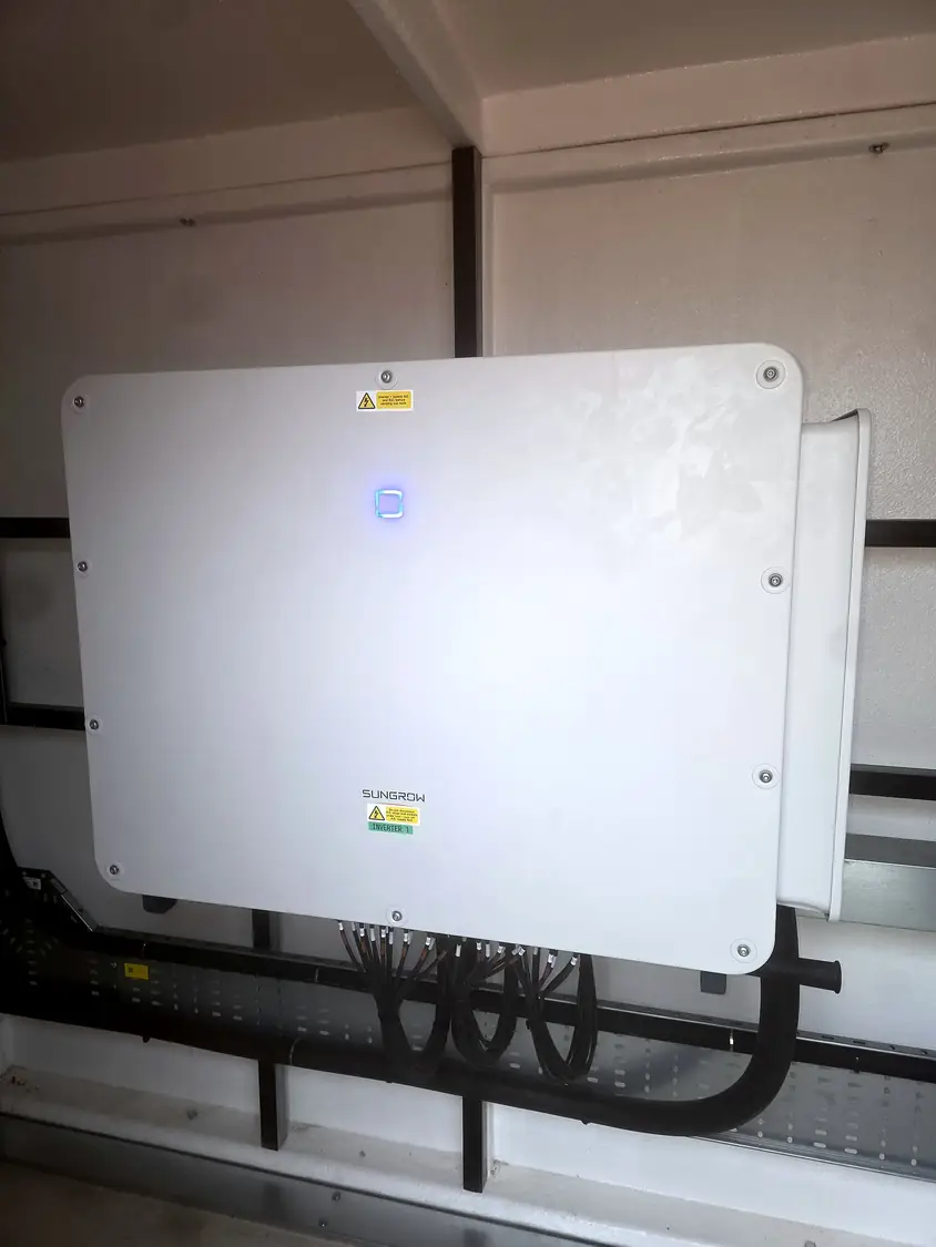 Sungrow inverter on strut, with cables run in tray below