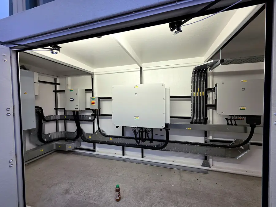 GRP kiosk with two Sungrow inverters, isolators and cable tray on strut