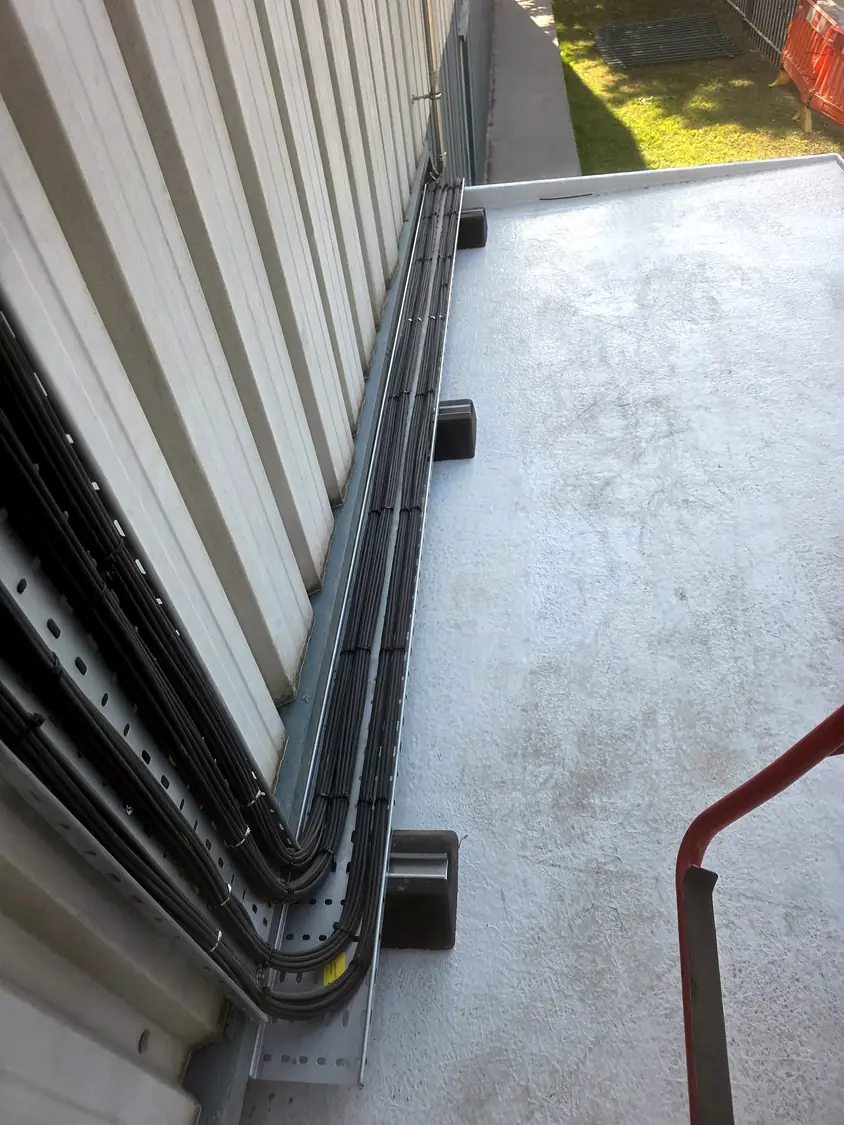 Cable tray at low level along the flat roof